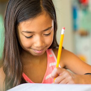 A girl working on schoolwork independently